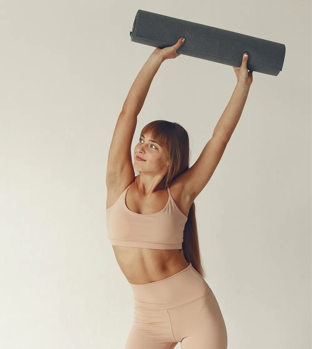 Woman holding a yoga mat